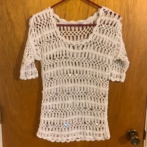 Crocheted, cover-up top with large sequin design. Very cute.